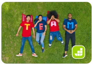 four team members lying on grass, wearing shirts with the word team on them