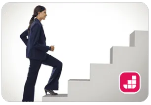 a professional women in business attire ascending a flight of stairs, symbolizing progress and ambition